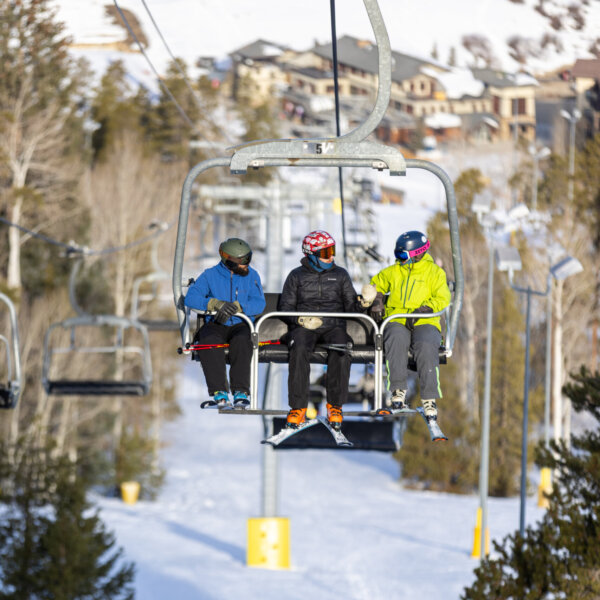 3 people riding quickdraw lift