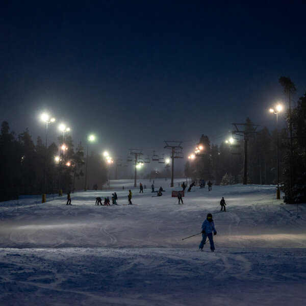 night ski slope with skiers